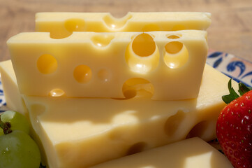Cheese collection, blocks of French emmentaler cheese with many round holes made from cow milk
