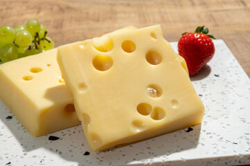 Cheese collection, blocks of French emmentaler cheese with many round holes made from cow milk