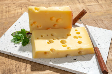 Cheese collection, blocks of French emmentaler cheese with many round holes made from cow milk