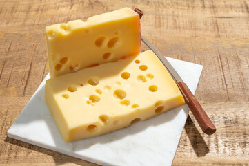 Cheese collection, blocks of French emmentaler cheese with many round holes made from cow milk