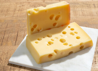 Cheese collection, blocks of French emmentaler cheese with many round holes made from cow milk