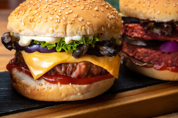 Tasty vegetarian cheeseburgers and hamburgers with round patties or burgers made from grains, vegetables and legumes