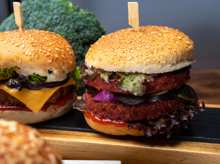 Tasty vegetarian cheeseburgers and hamburgers with round patties or burgers made from grains, vegetables and legumes