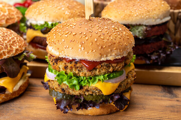 Tasty vegetarian cheeseburgers and hamburgers with round patties or burgers made from grains, vegetables and legumes