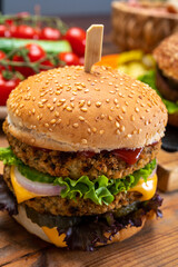 Tasty vegetarian cheeseburgers and hamburgers with round patties or burgers made from grains, vegetables and legumes