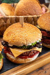 Tasty vegetarian cheeseburgers and hamburgers with round patties or burgers made from grains, vegetables and legumes