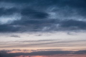 Lenticular and cumulus clouds over the evening sky