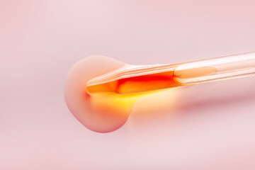Liquid pipette orange  gel or serum glass of microscope background