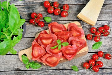 Red heart ravioli with tomato, mozzarella and basil