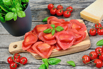 Red heart ravioli with tomato, mozzarella and basil