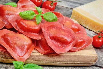 Red heart ravioli with cherry tomato, mozzarella, parmesan and basil