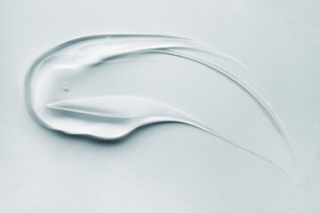 Cream gel gray blue transparent cosmetic sample texture with bubbles blue background