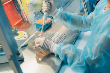Scientist working at the laboratory. Life scientists researching in laboratory. Focused female...