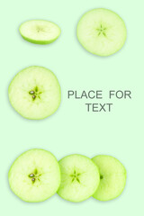Naklejka na ściany i meble Creative layout with green apples on a light background. Food concept. Copy spaсe