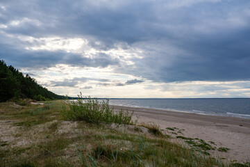 empty sandy beach by the sea with rocks