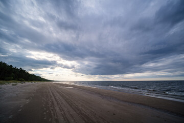 empty sandy beach by the sea with rocks