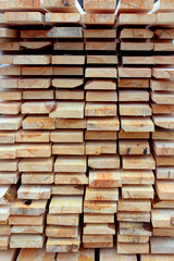 A bunch of planks stacked one-on-one. Background of wooden board. Natural wood texture