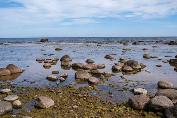 Fototapeta na wymiar empty sandy beach by the sea with rocks
