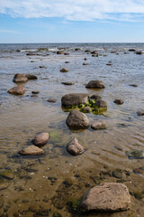 empty sandy beach by the sea with rocks