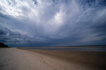 empty sandy beach by the sea with rocks