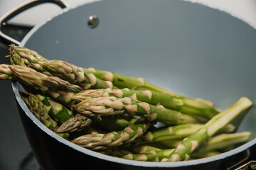 Fresh green seasonal asparagus in a pot ready to cook