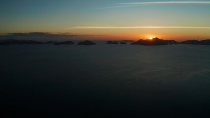 aerial view tropical sunset over the sea background of mountains. El nido, Philippines, Palawan. seascape with tropical islands at sunset time. Summer and travel vacation concept