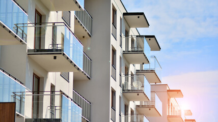 Architectural details of modern apartment building. Modern european residential apartment building complex with sunlight.