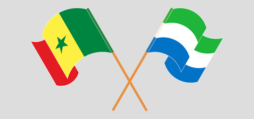 Crossed and waving flags of Sierra Leone and Senegal