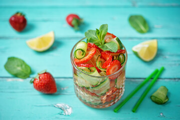 Strawberry lime cucumber mint fresh cocktail in a glass
