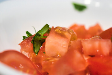 juicy tomato chunks with peices of chopped basil
