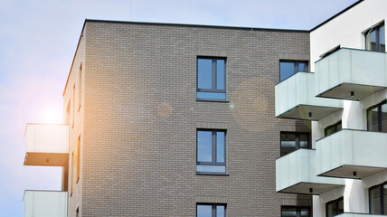 Architectural details of modern apartment building. Modern european residential apartment building complex with sunlight.