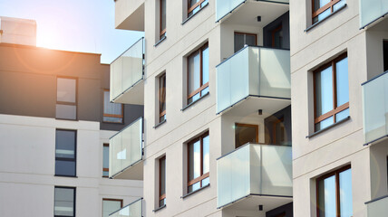 Architectural details of modern apartment building. Modern european residential apartment building complex with sunlight.