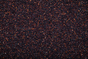 Peruvian seeds black quinoa, close-up. Top view. Cereal contains a large array of proteins, antioxidants, dietary fibers, vitamins and mineral key to healthy diet