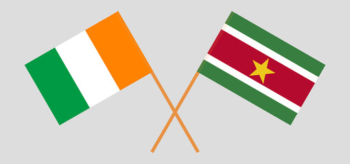 Crossed flags of Republic of Ivory Coast and Suriname. Official colors. Correct proportion