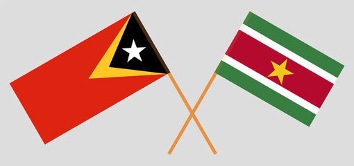 Crossed flags of East Timor and Suriname. Official colors. Correct proportion