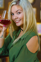 Girl with alcohol glass in pub club