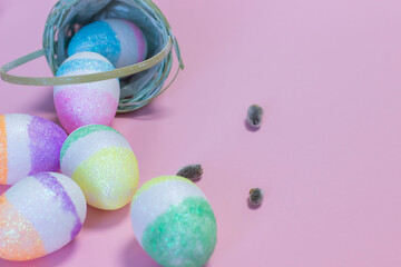 little basket with Easter eggs on a pink background. easter holiday concept.