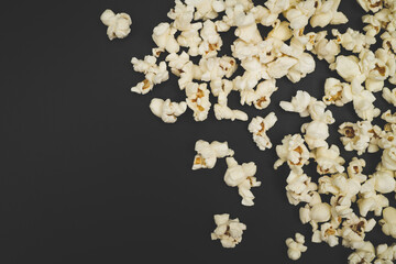 Close up of freshly popped popcorn on a black background