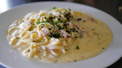 italian food spaghetti carbonara with sauce in a plate