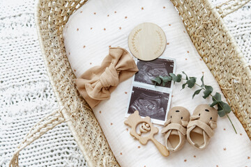 Flat lay composition with cute baby items in basket. The concept of awaiting baby, pregnancy - 429881932