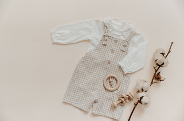 Fashion baby outfit on beige background. Natural linen textil, eco friendly. Cotton. Boho style...