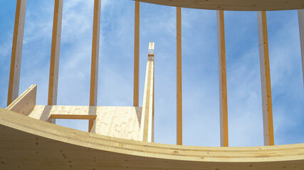 BOTTOM UP: Shot of the bare top floor of unfinished glued laminated timber house