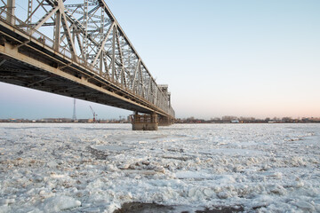 bridge over the Northern Dvina river with spring ice drift. evening time.