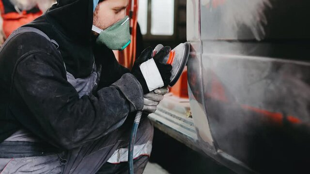 polishing putty on a car body, car restoration. Preparation for painting.