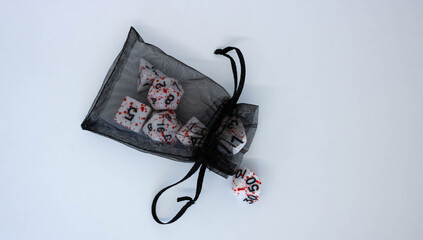 Black transparent pouch and dice isolated on white background.Flying dice