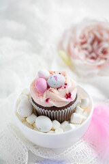 Easter chocolate cupcake with caramel filling and decoration in the form of small Easter eggs from marzipan