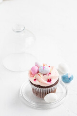Easter chocolate cupcake with caramel filling and decoration in the form of small Easter eggs from marzipan