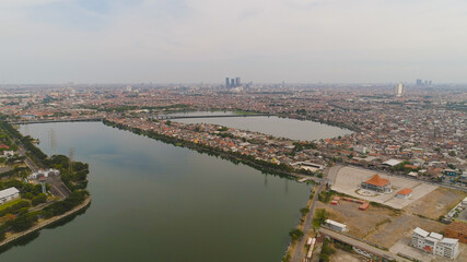 Naklejka premium Aerial cityscape city Surabaya with skyscrapers, buildings and houses. urban environment in asia city skyline with skyscrapers and business centers java, indonesia