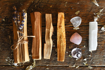 A close up image of holy wood incense sticks with healing rose quartz and amethyst crystals. 