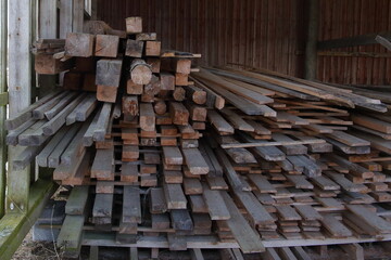 A storage of old rough sawn timber in a barn
